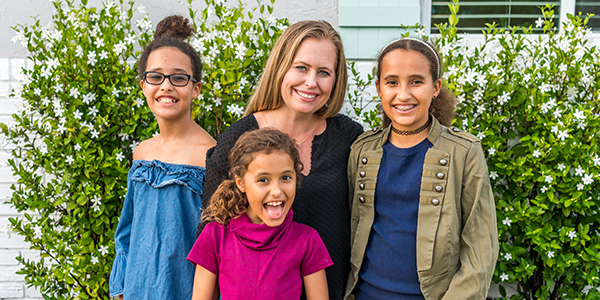 Smiling mom and daughters