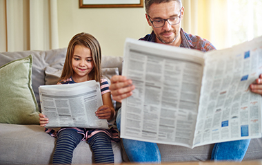 Dad and daughter reading the news