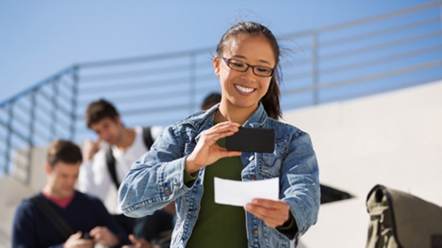 teen taking a photo of a check