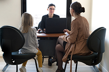 Investigator interviewing an adult and a child