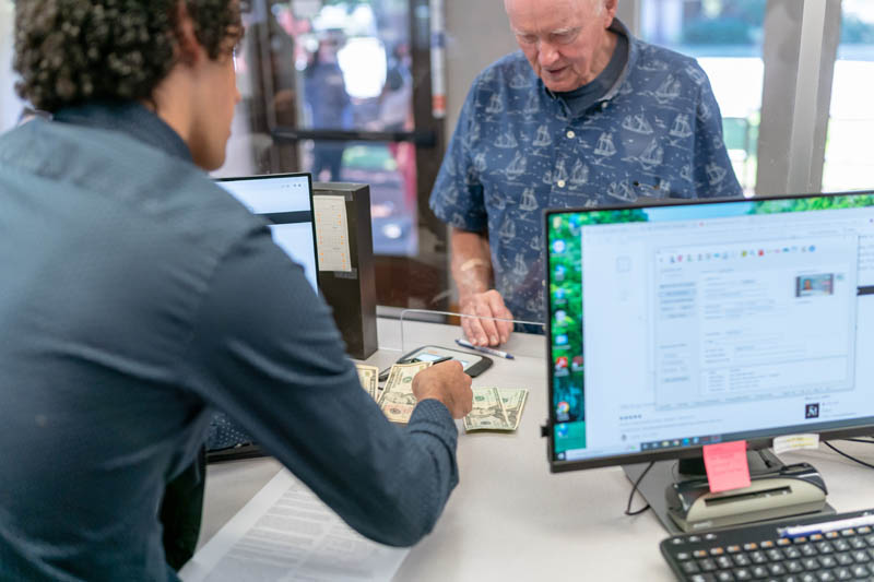 The exchange of money at a bank to depict financial exploitation and financial professionals possible role in finding solutions.