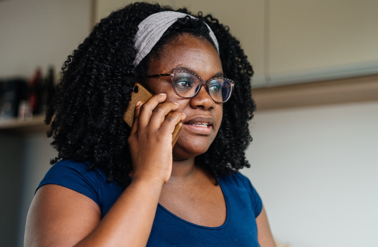 Woman reporting through phone.