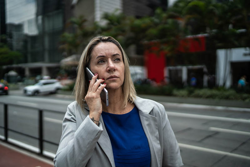 Woman reporting through phone.