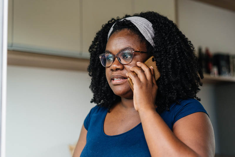Woman reporting through phone.