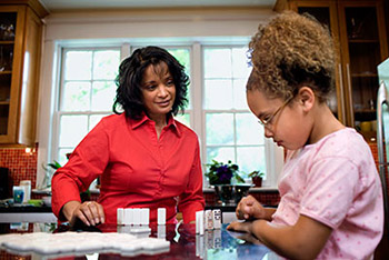 woman playing Dominoes with a girl