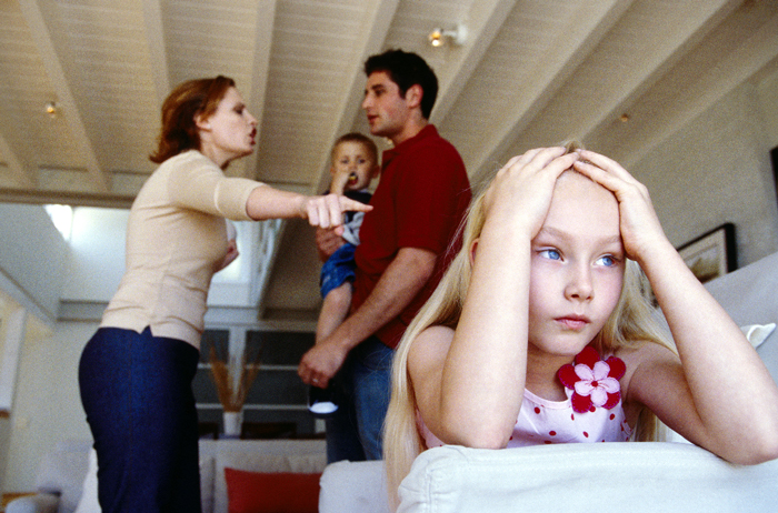 Parents arguing, child frustrated and aware.