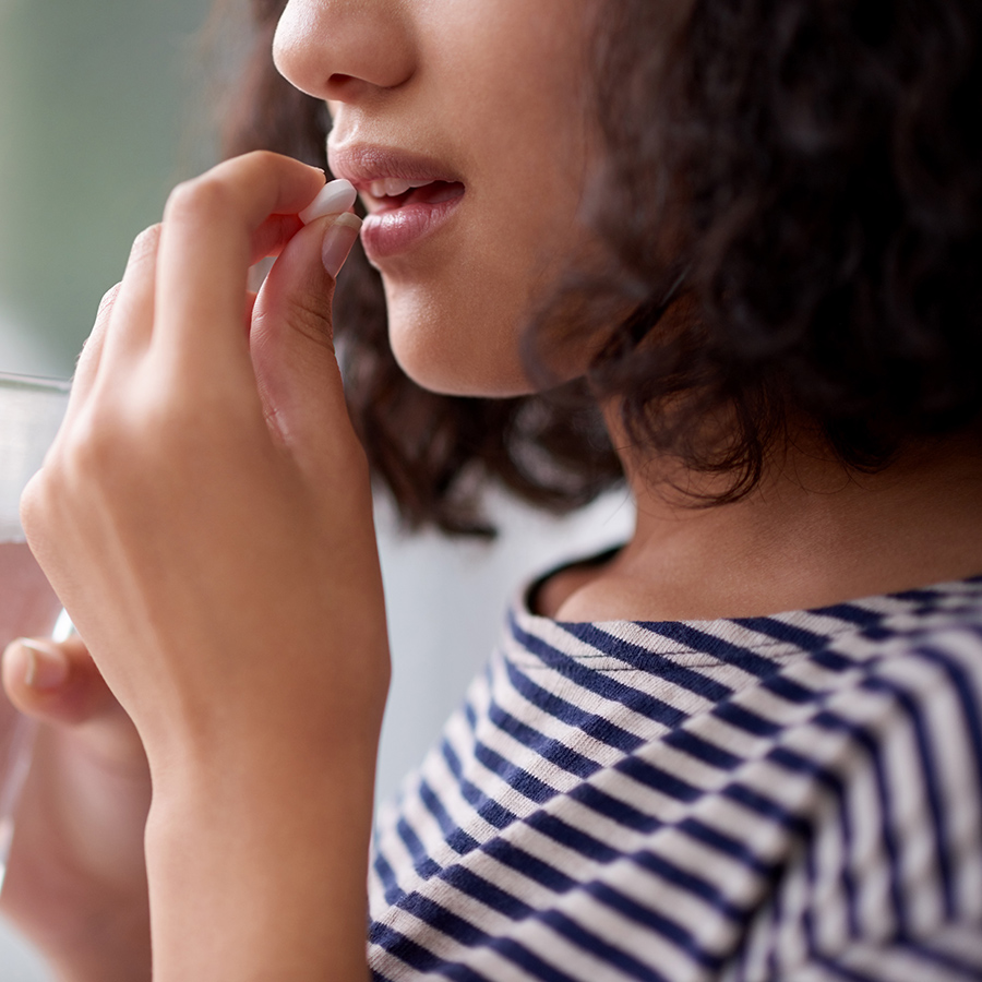 girl taking a pill